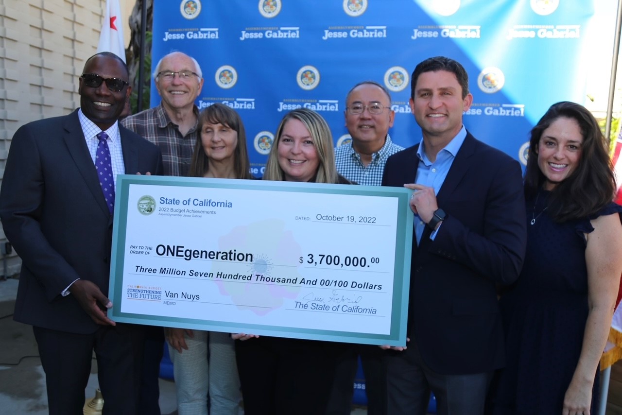 Asm. Gabriel presents novelty check of $3.7 million to ONEgeneration board members.